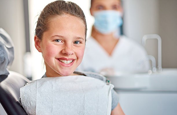 Girl smiling during dentist visit - Harrison Pediatric Dentistry